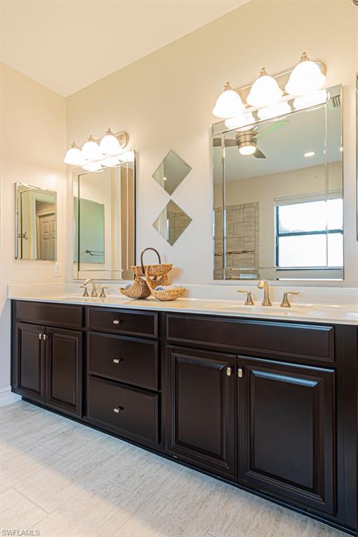 7761 Bucks Run Drive Naples, FL 34120 - Photo 24 of 50 a bathroom with a granite countertop sink and a mirror