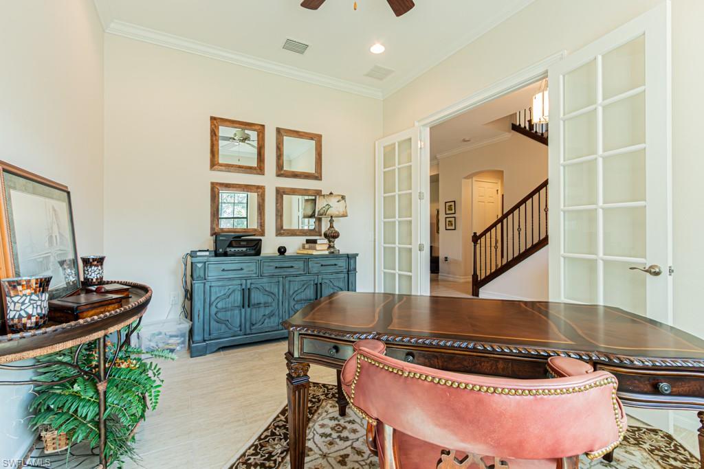7761 Bucks Run Drive Naples, FL 34120 - Photo 28 of 50 a kitchen with a stove and cabinets