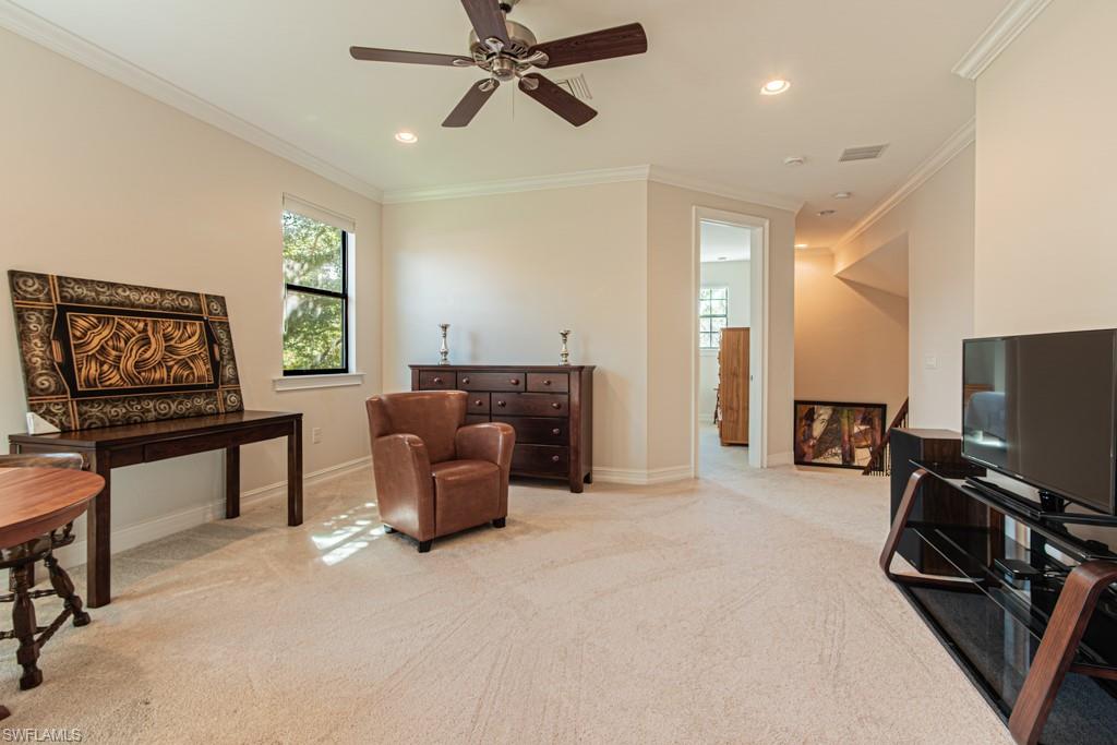 7761 Bucks Run Drive Naples, FL 34120 - Photo 30 of 50 a living room with furniture a flat screen tv and a window