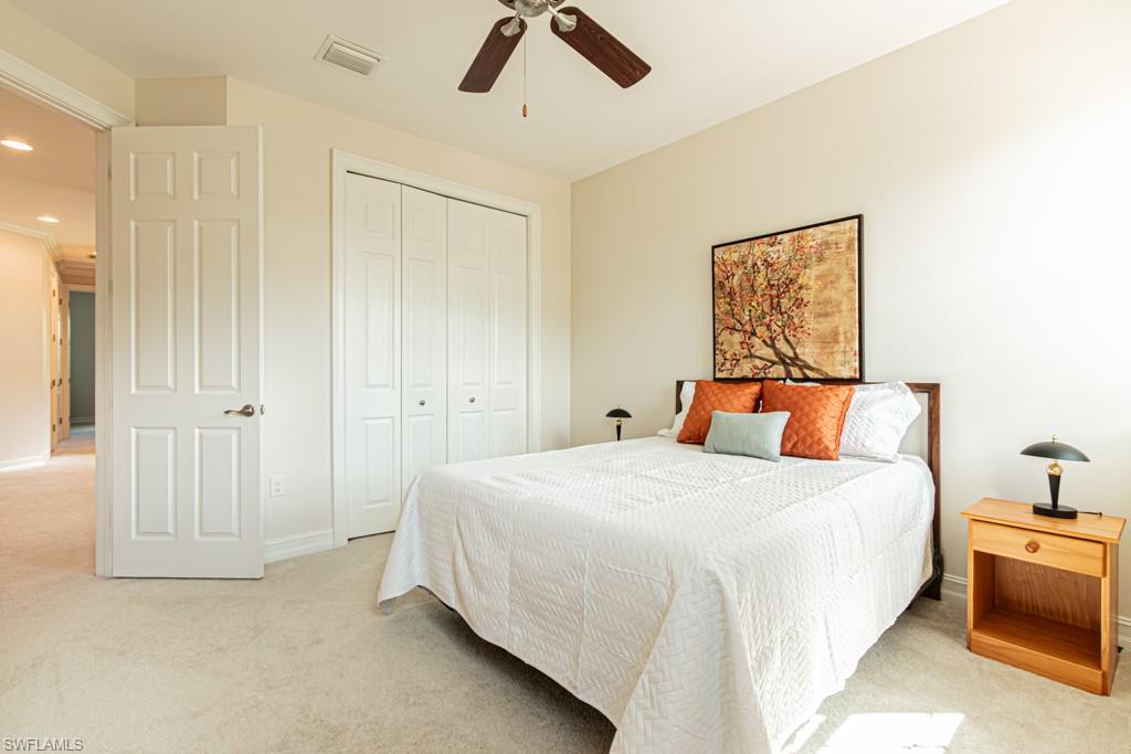 7761 Bucks Run Drive Naples, FL 34120 - Photo 33 of 50 a bedroom with a bed and a chandelier