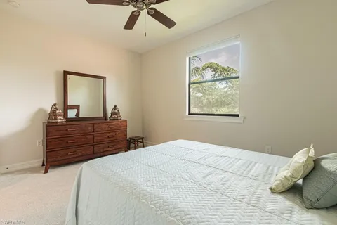 a bedroom with a bed and a dresser