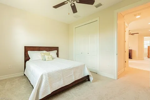 a bedroom with a bed and ceiling fan