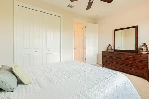 a bedroom with a bed and a dresser