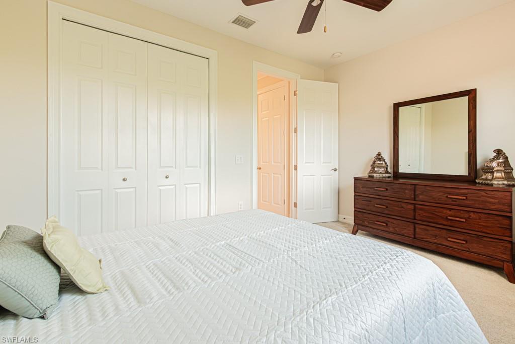 7761 Bucks Run Drive Naples, FL 34120 - Photo 39 of 50 a bedroom with a bed and a dresser