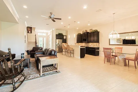 a living room with furniture and kitchen view