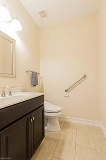 a bathroom with a sink a toilet and mirror