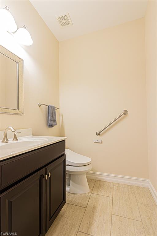 7761 Bucks Run Drive Naples, FL 34120 - Photo 41 of 50 a bathroom with a sink a toilet and mirror