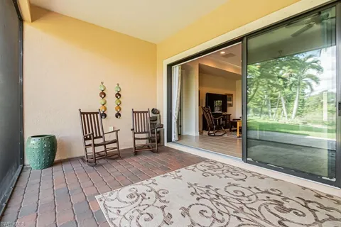 a hallway with a bed and a window