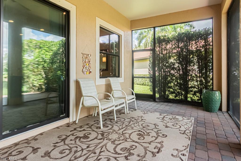7761 Bucks Run Drive Naples, FL 34120 - Photo 45 of 50 a living room with a couch and a window