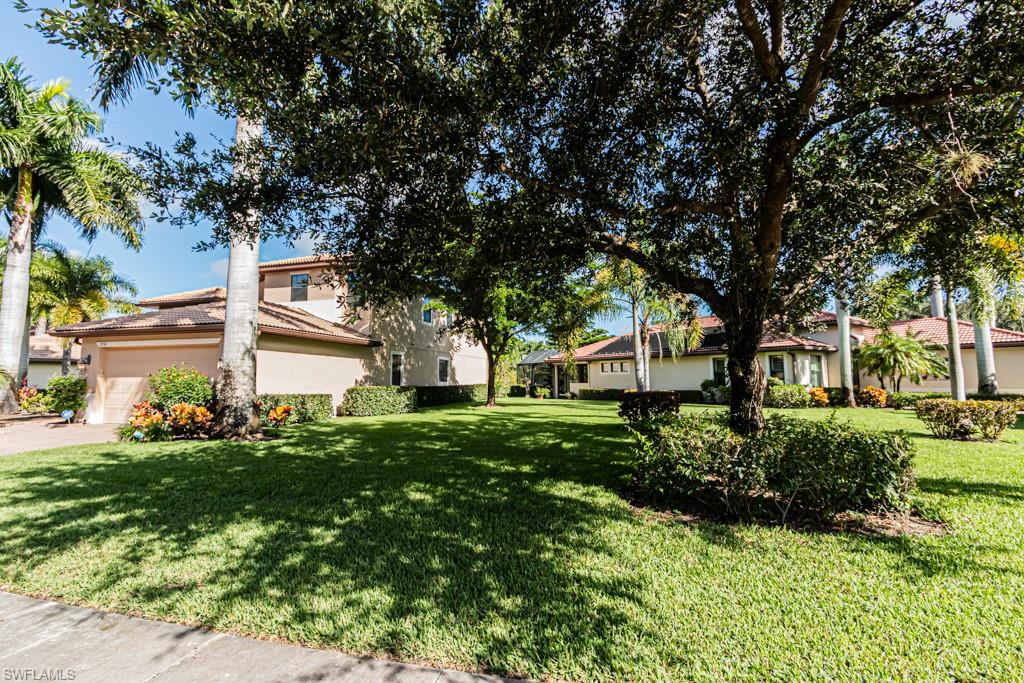 7761 Bucks Run Drive Naples, FL 34120 - Photo 47 of 50 a front view of a house with a yard