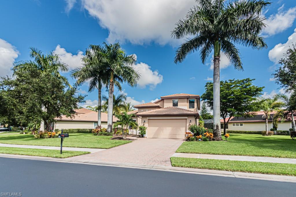 7761 Bucks Run Drive Naples, FL 34120 - Photo 49 of 50 a front view of a house with a yard and garage