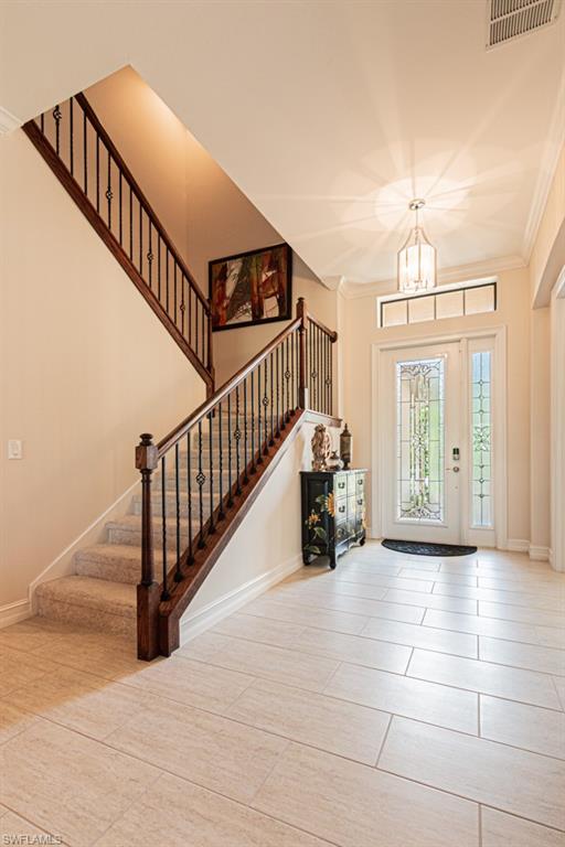 7761 Bucks Run Drive Naples, FL 34120 - Photo 8 of 50 a view of an entryway with dining room and stairs