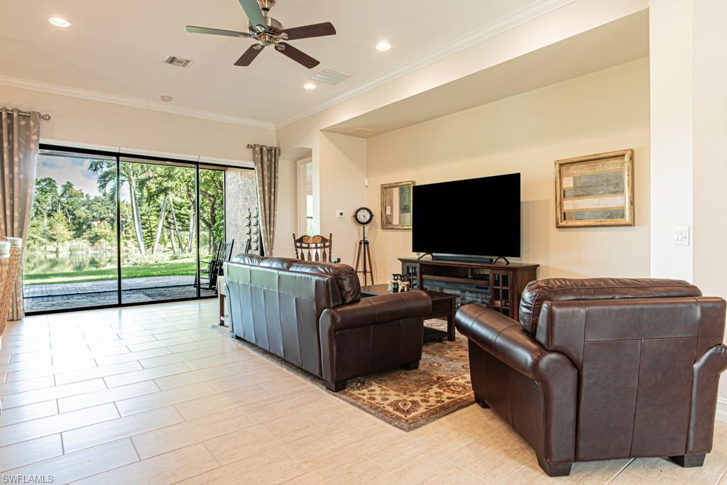 7761 Bucks Run Drive Naples, FL 34120 - Photo 9 of 50 a living room with furniture and a flat screen tv