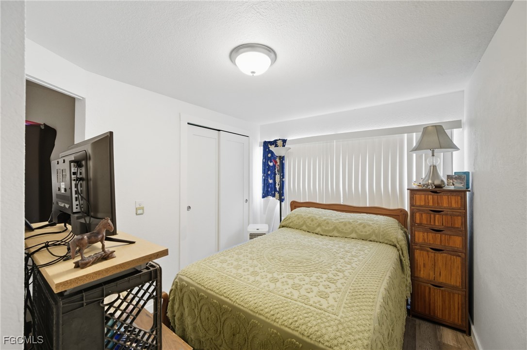 136 Lexington Avenue Fort Myers, FL 33908 - Photo 11 of 31 a bedroom with a bed and a table in it