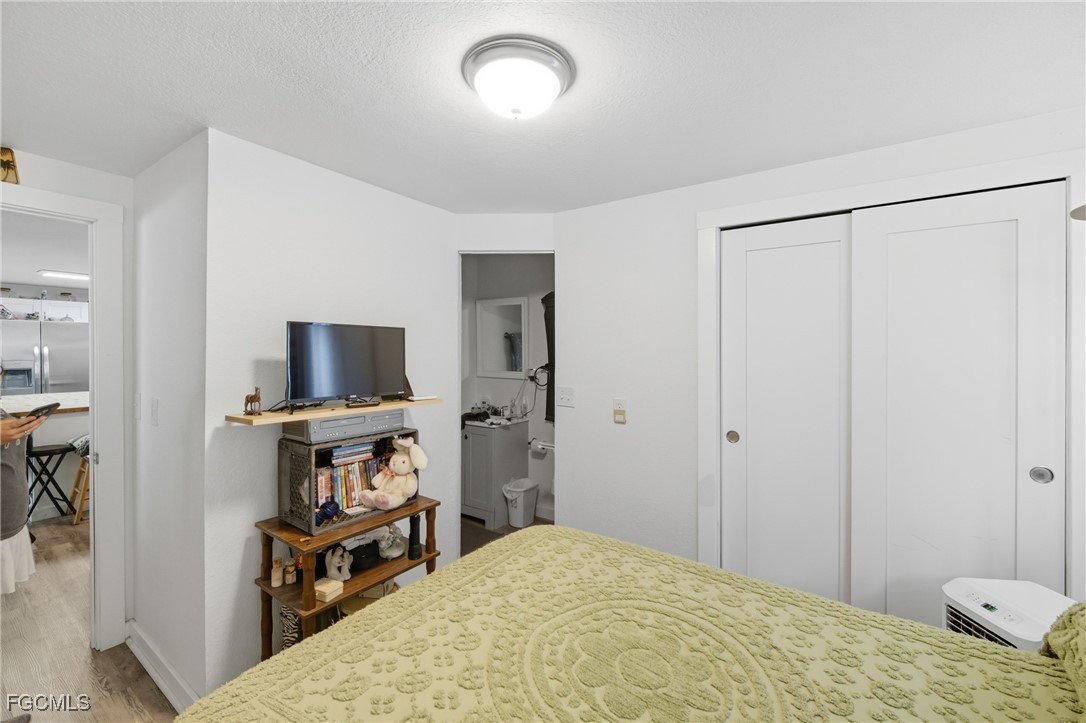 136 Lexington Avenue Fort Myers, FL 33908 - Photo 12 of 31 a bedroom with a bed and a flat screen tv