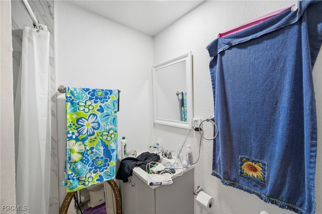 136 Lexington Avenue Fort Myers, FL 33908 - Photo 13 of 31 a bathroom with a sink mirror and vanity