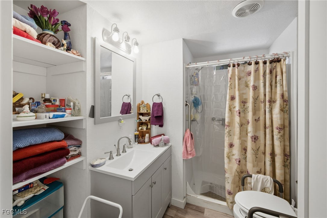 136 Lexington Avenue Fort Myers, FL 33908 - Photo 18 of 31 a bathroom with a sink vanity mirror and toilet