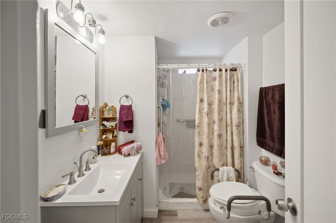 136 Lexington Avenue Fort Myers, FL 33908 - Photo 19 of 31 a bathroom with a sink mirror and shower