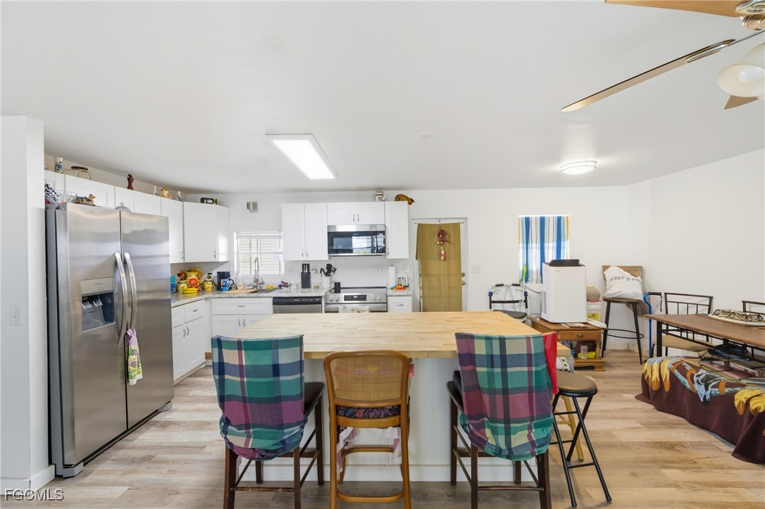 136 Lexington Avenue Fort Myers, FL 33908 - Photo 7 of 31 a dining area with stainless steel appliances a table and chairs