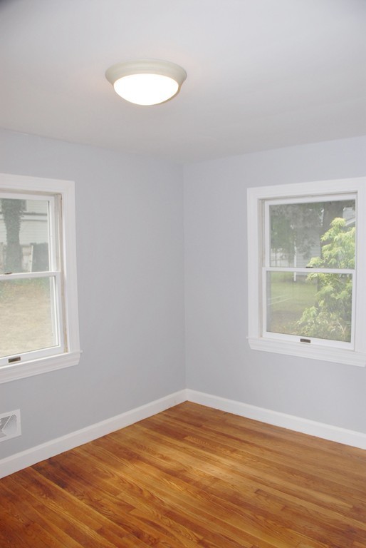 17 Margaret Road Hamilton, MA 01982 - Photo 17 of 24 a view of an empty room with wooden floor and a window