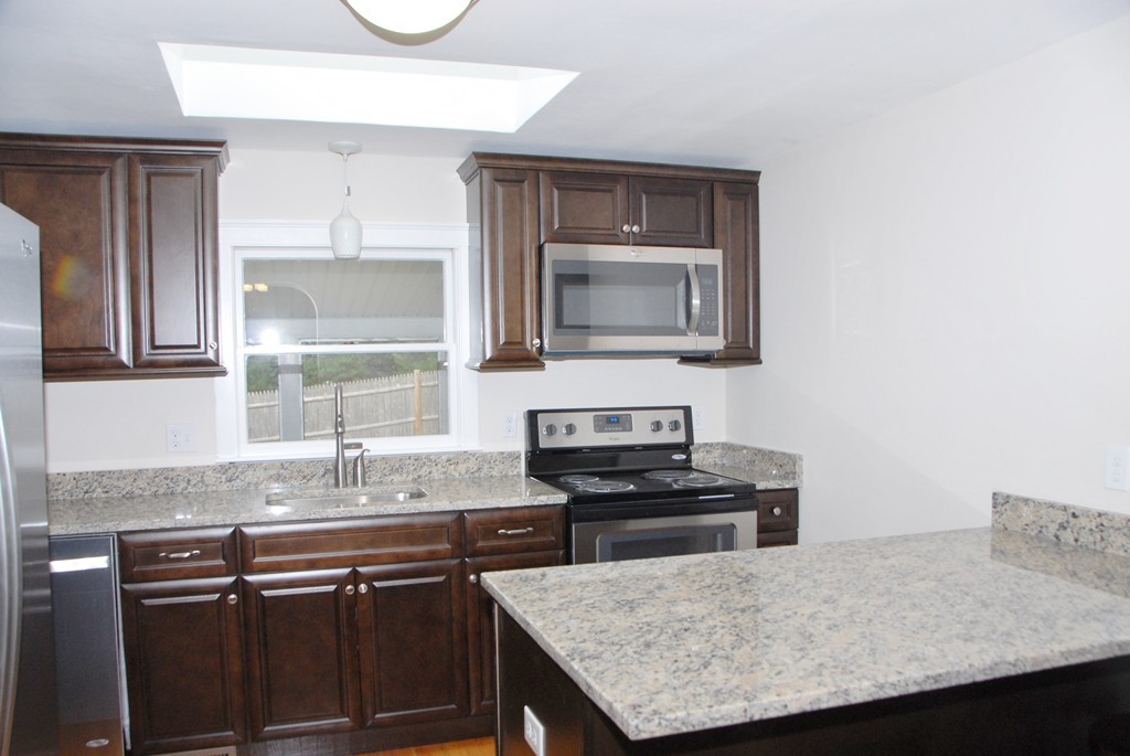 17 Margaret Road Hamilton, MA 01982 - Photo 5 of 24 a kitchen with granite countertop cabinets stainless steel appliances and a counter space