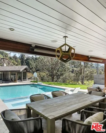 a view of a patio with table and chairs