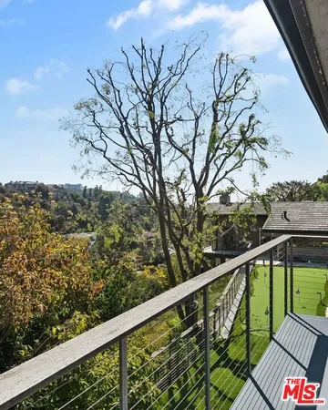 a view of a balcony with wooden fence and floor