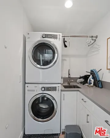 a utility room with sink dryer and washer