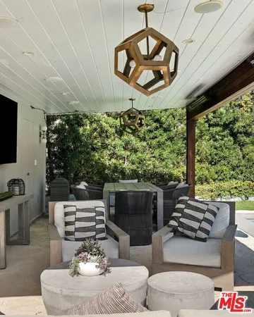 a living room with furniture a fireplace and a large window