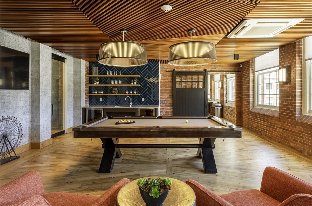 165 Thorndike Street, Unit 403 Lowell, MA 01852 - Photo 5 of 10 a room with furniture pool table and windows