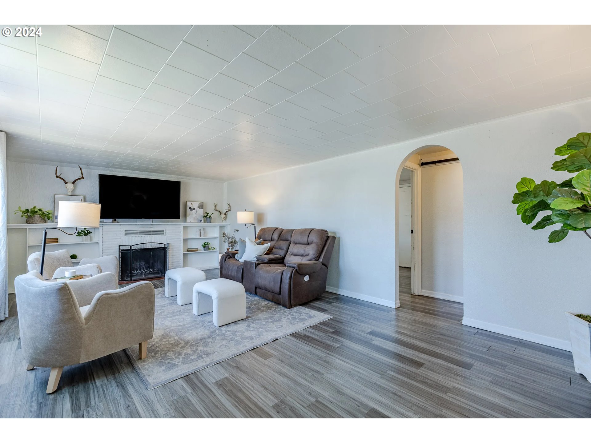 447 19th Street Springfield, OR 97477 - Photo 3 of 23 a living room with furniture a fireplace and a flat screen tv