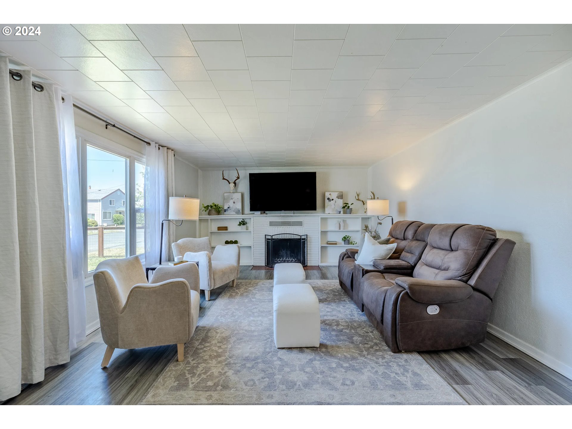 447 19th Street Springfield, OR 97477 - Photo 4 of 23 a living room with furniture a fireplace and a flat screen tv