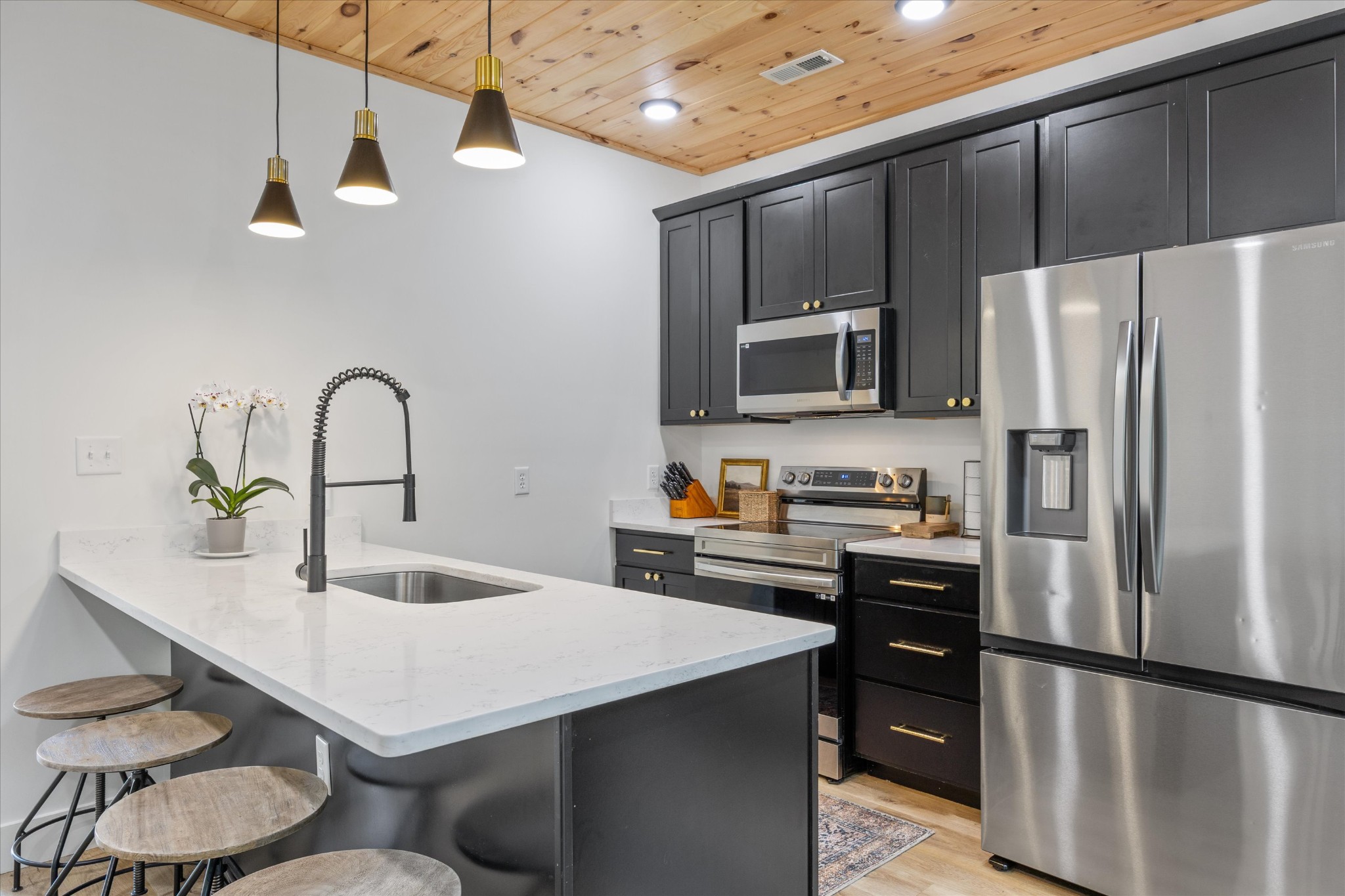 1134 Reedmont Way Sevierville, TN 37876 - Photo 7 of 42 a kitchen with kitchen island a refrigerator stove and microwave
