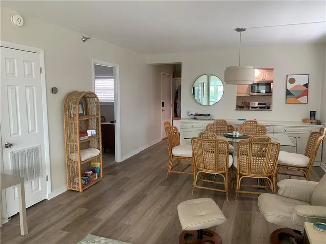 a dining room with furniture a window and wooden floor