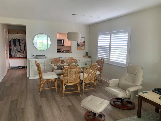 a view of a dining room with furniture and a chandelier