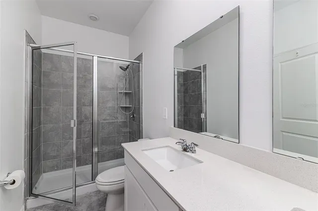 a bathroom with a sink toilet and shower