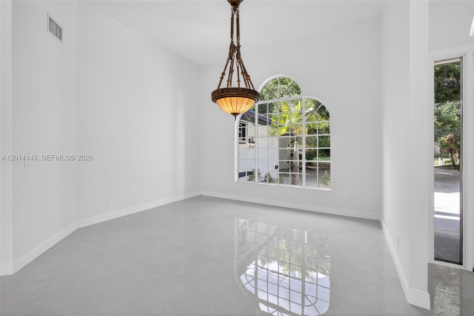 19558 Red Gum Trail Jupiter, FL 33458 - Photo 13 of 81 a view of wooden floor and a chandelier in a room