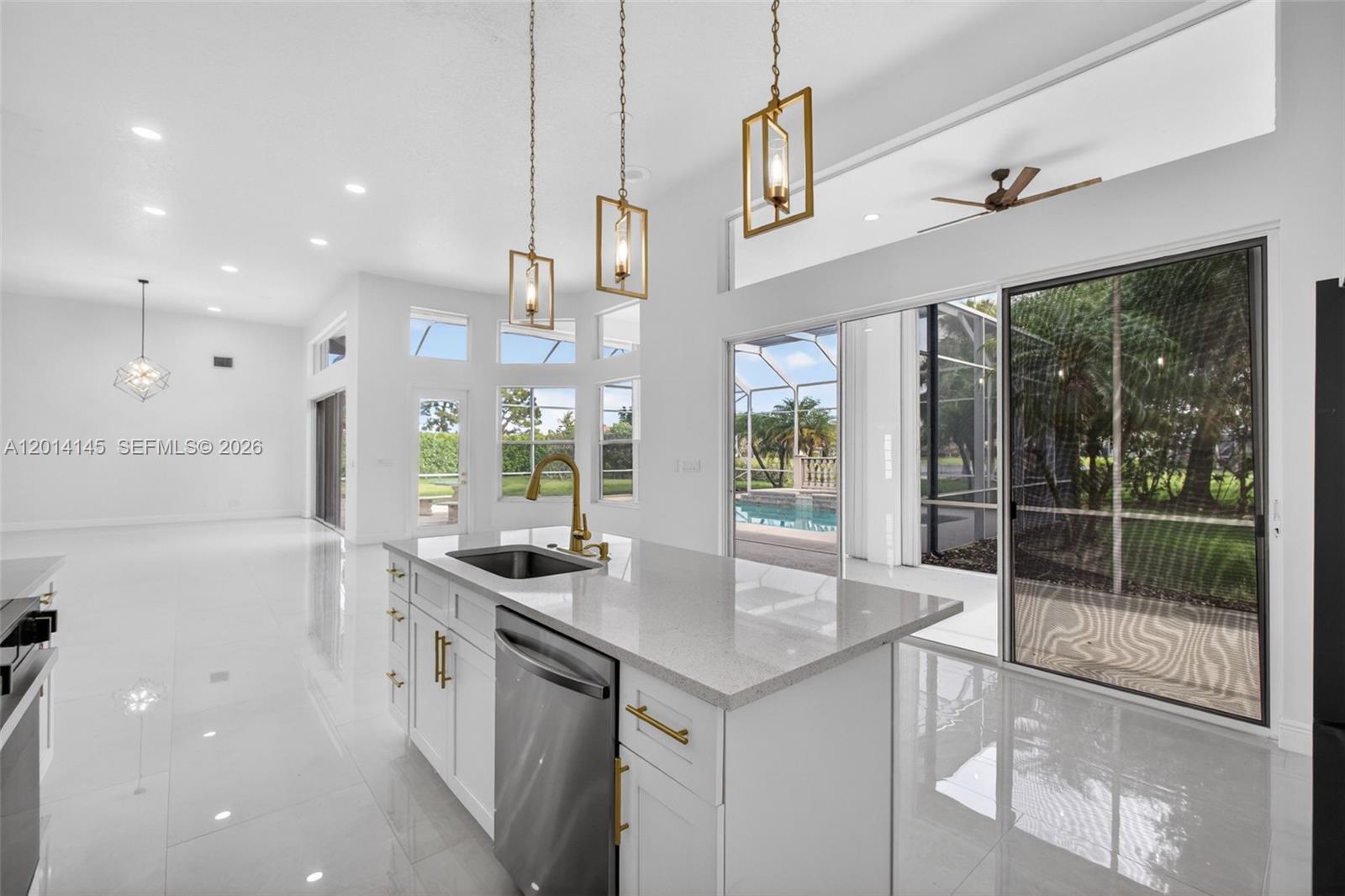 19558 Red Gum Trail Jupiter, FL 33458 - Photo 3 of 81 a kitchen with stainless steel appliances granite countertop a sink and a large mirror