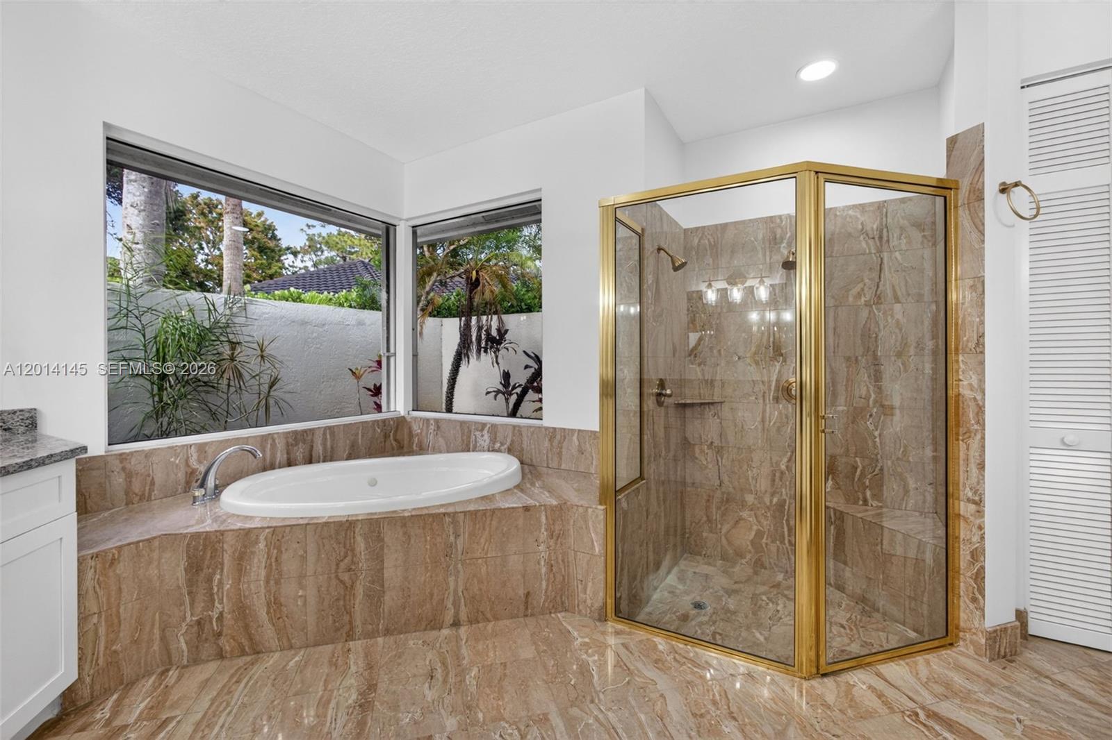 19558 Red Gum Trail Jupiter, FL 33458 - Photo 39 of 81 a bathroom with a tub and shower