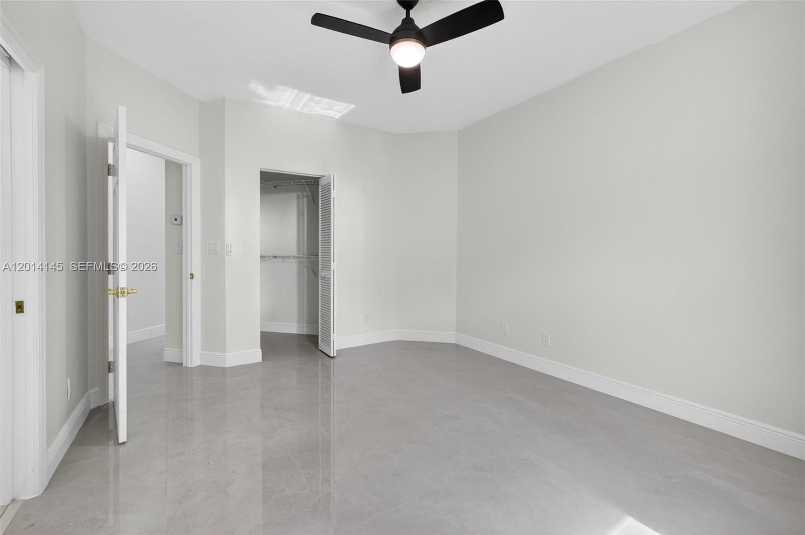 19558 Red Gum Trail Jupiter, FL 33458 - Photo 42 of 81 an empty room with a ceiling fan