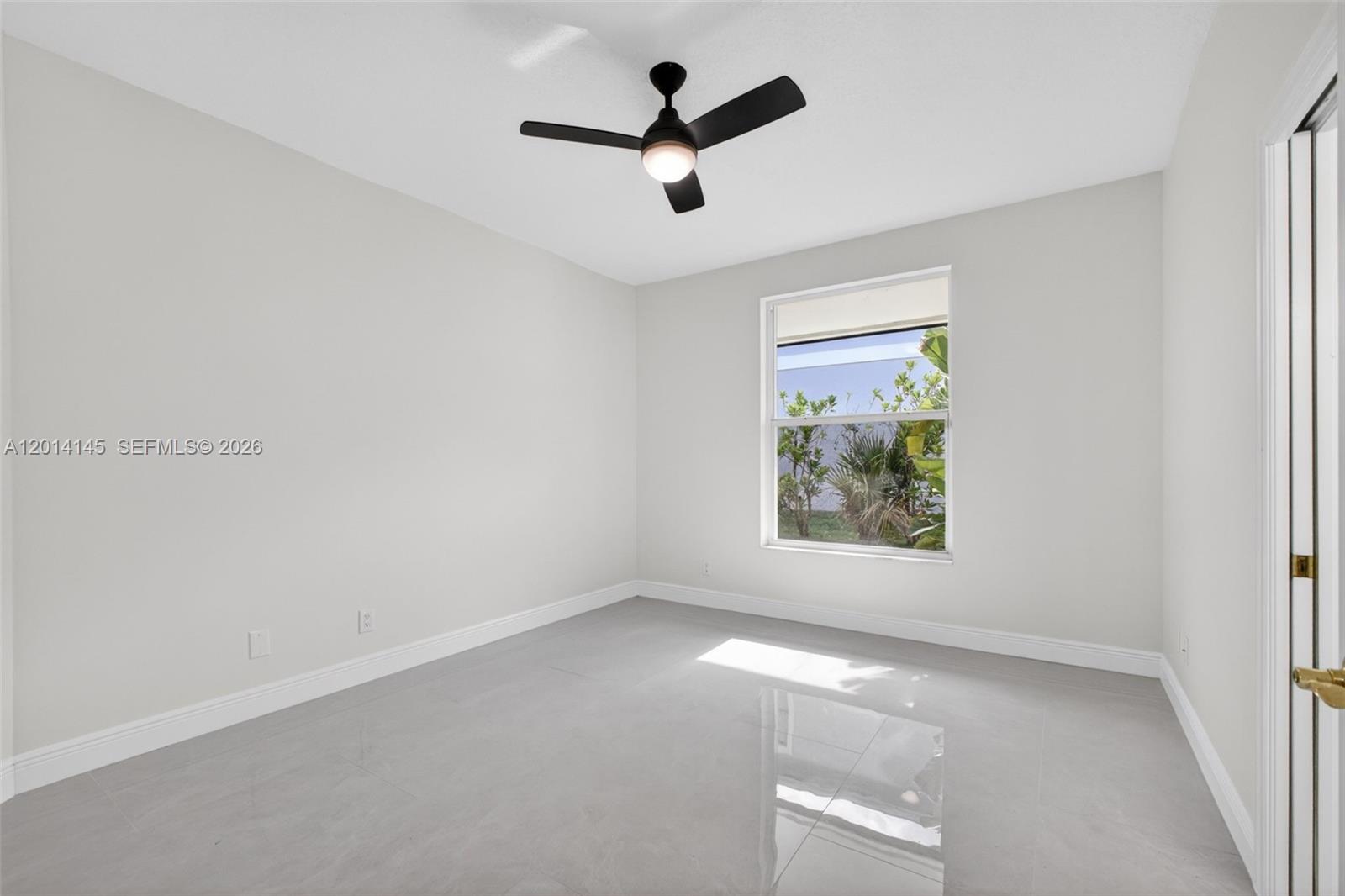 19558 Red Gum Trail Jupiter, FL 33458 - Photo 43 of 81 an empty room with a ceiling fan and window