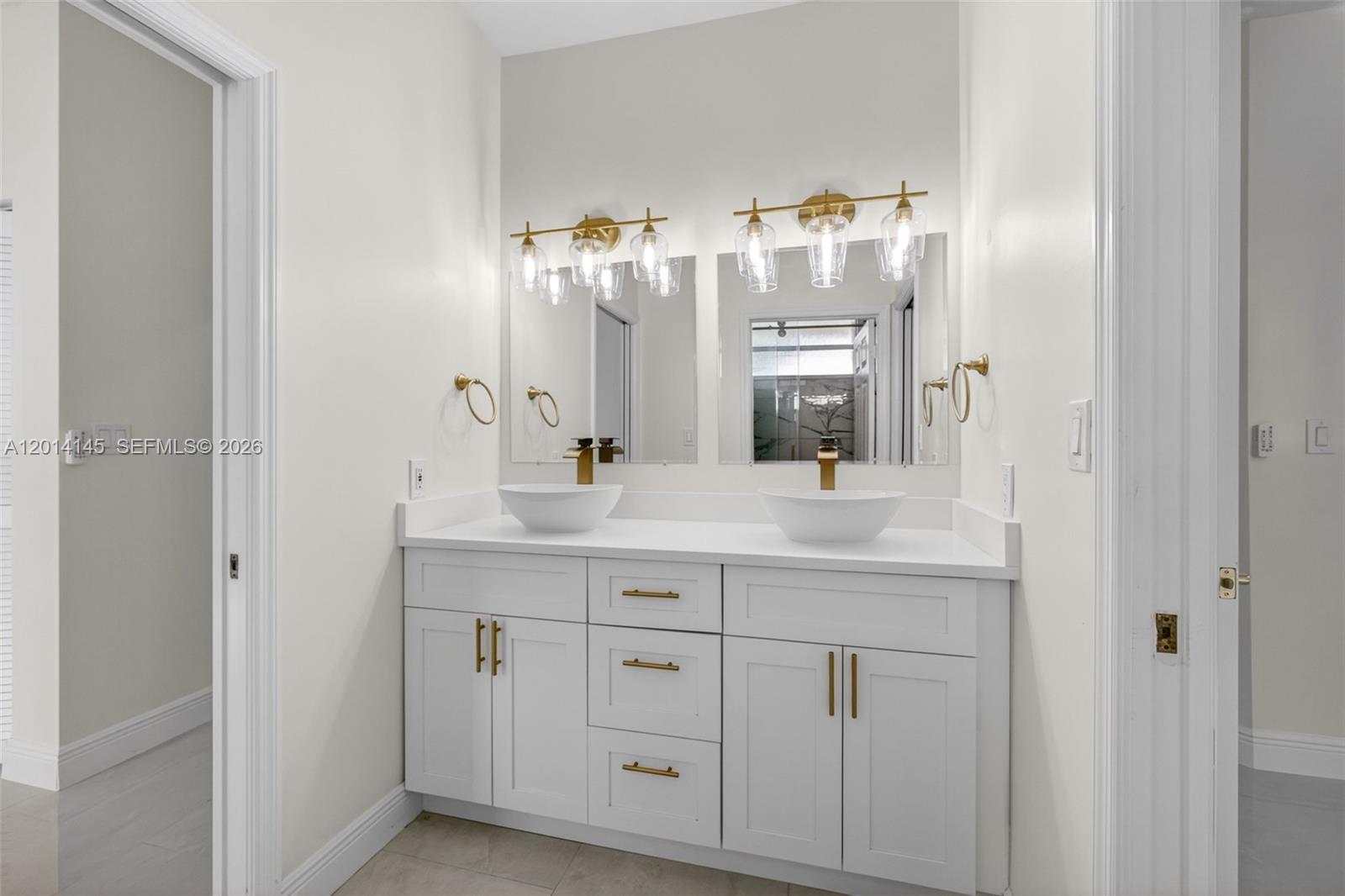 19558 Red Gum Trail Jupiter, FL 33458 - Photo 44 of 81 a bathroom with a double vanity sink and a mirror