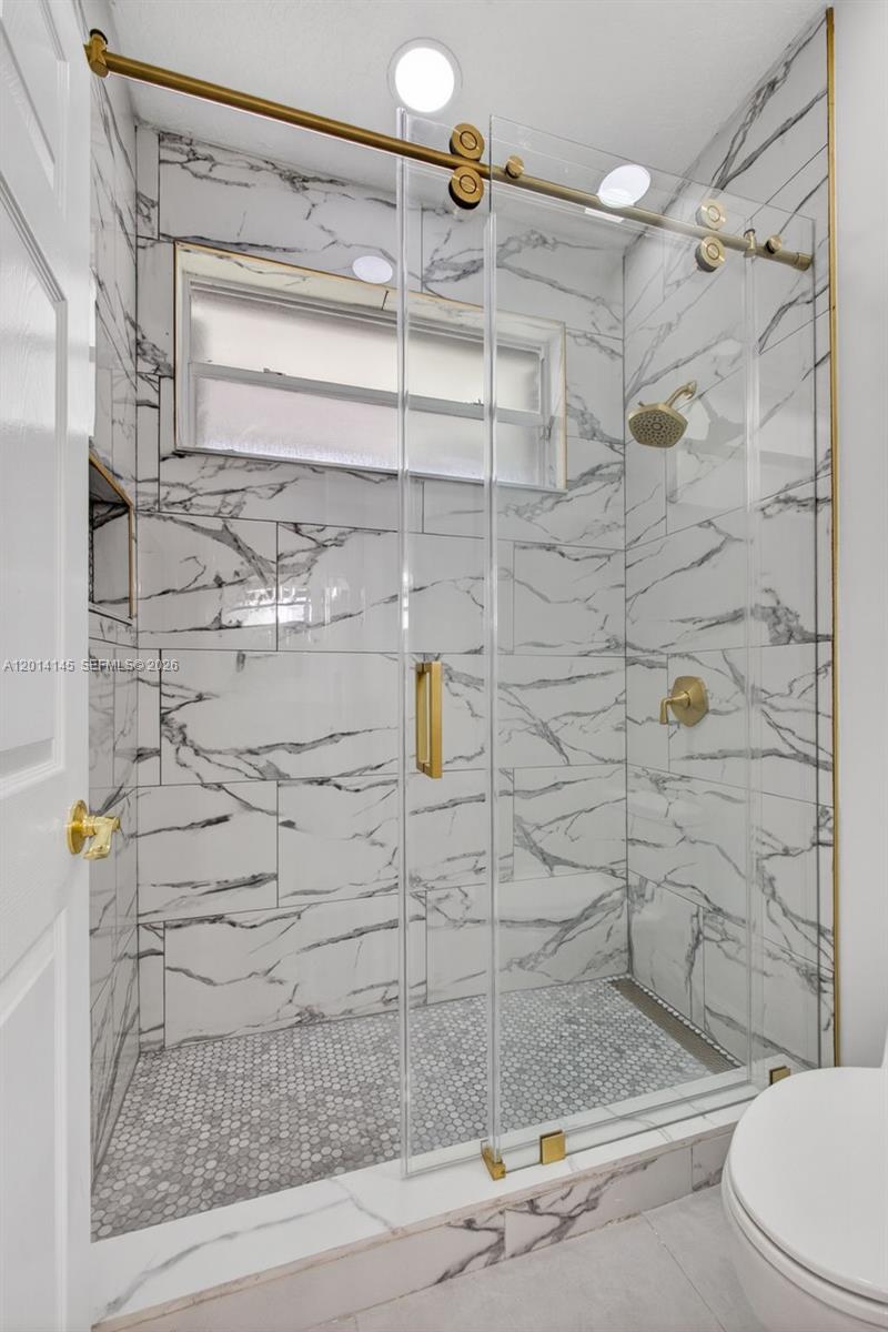 19558 Red Gum Trail Jupiter, FL 33458 - Photo 46 of 81 a bathroom with a shower and a toilet