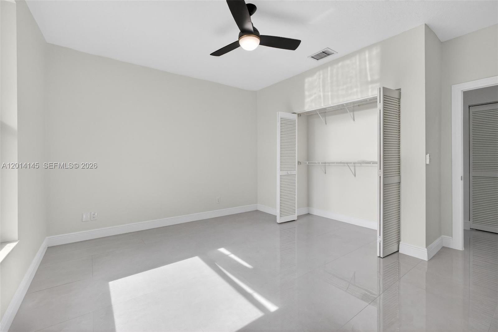 19558 Red Gum Trail Jupiter, FL 33458 - Photo 48 of 81 a view of an empty room with a ceiling fan