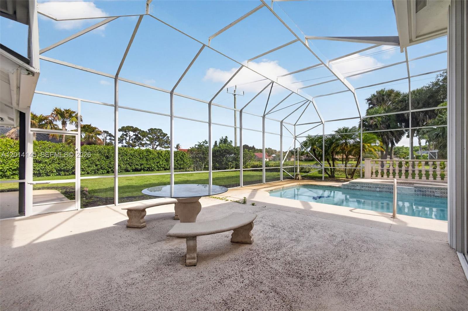 19558 Red Gum Trail Jupiter, FL 33458 - Photo 5 of 81 a view of a child park with a floor to ceiling window