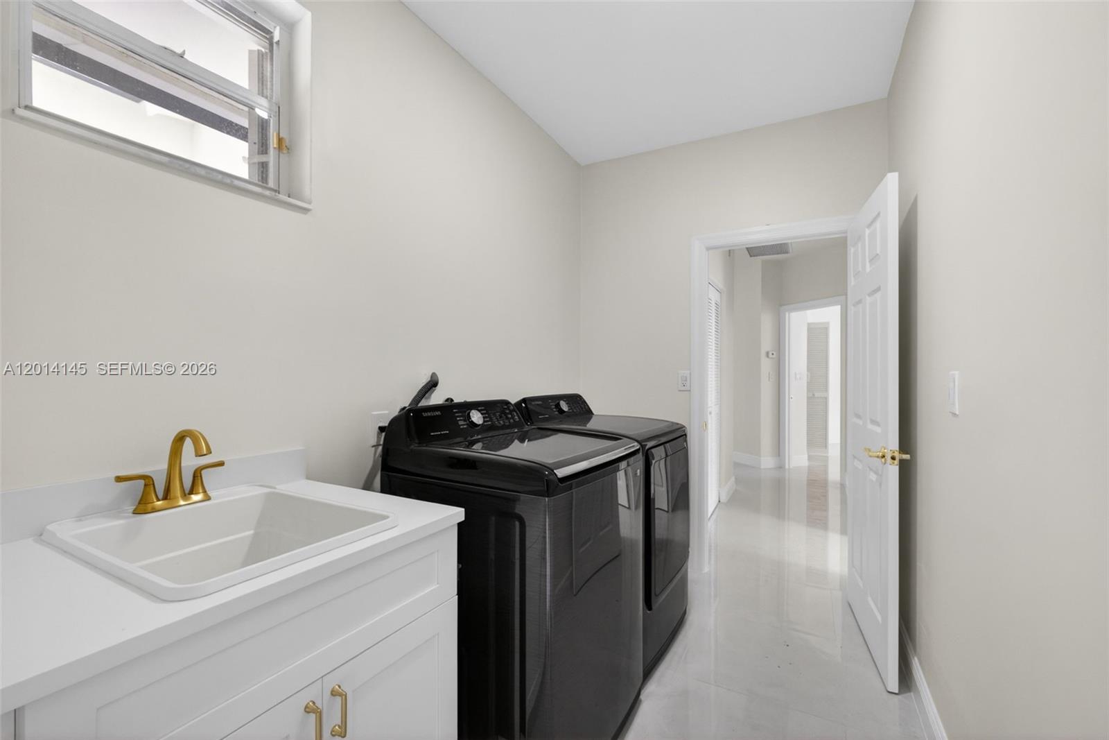 19558 Red Gum Trail Jupiter, FL 33458 - Photo 51 of 81 a utility room with sink dryer and washer