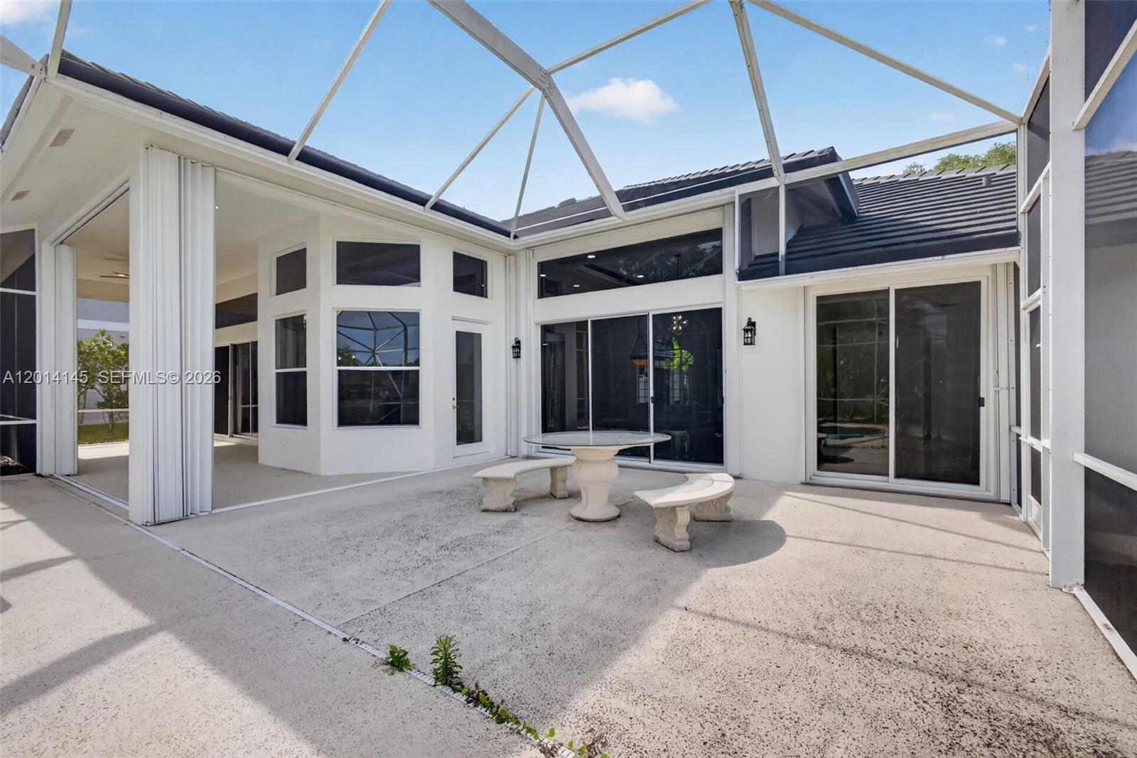 19558 Red Gum Trail Jupiter, FL 33458 - Photo 53 of 81 a view of a patio with table and chairs and wooden floor
