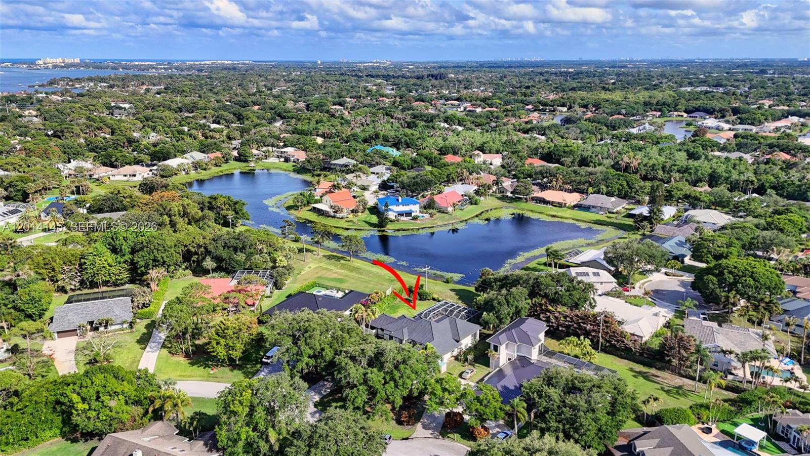 19558 Red Gum Trail Jupiter, FL 33458 - Photo 71 of 81 an aerial view of residential houses with outdoor space and trees