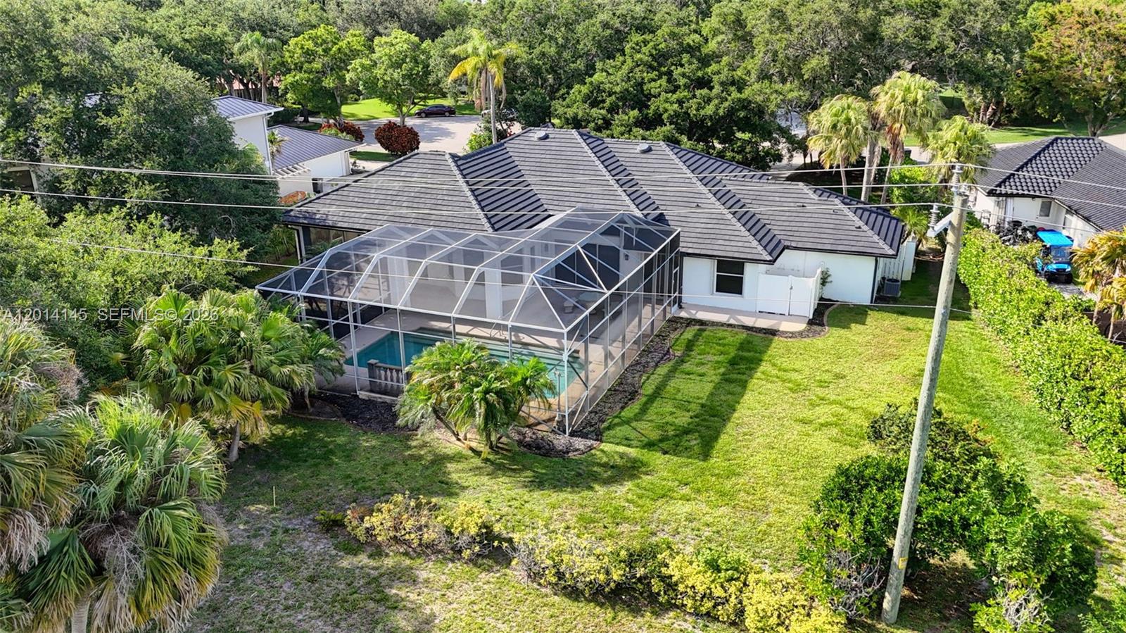 19558 Red Gum Trail Jupiter, FL 33458 - Photo 79 of 81 an aerial view of a house with a big yard potted plants and large tree