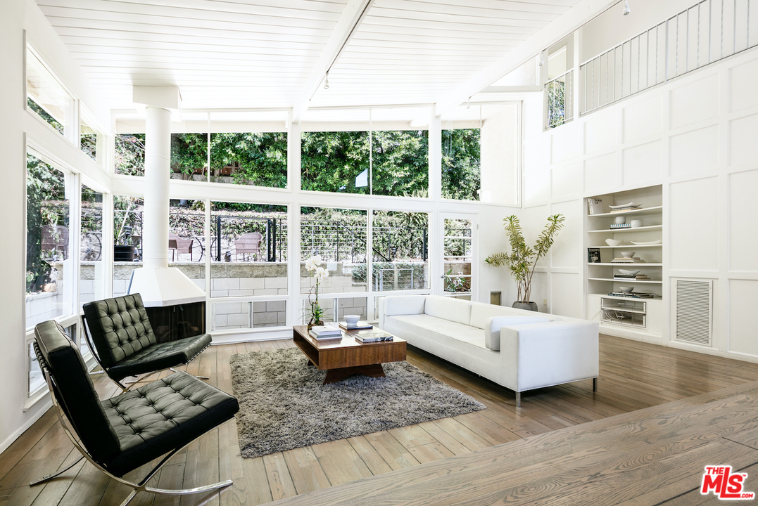 348 Sycamore Road Santa Monica, CA 90402 - Photo 2 of 12 a living room with furniture and a floor to ceiling window